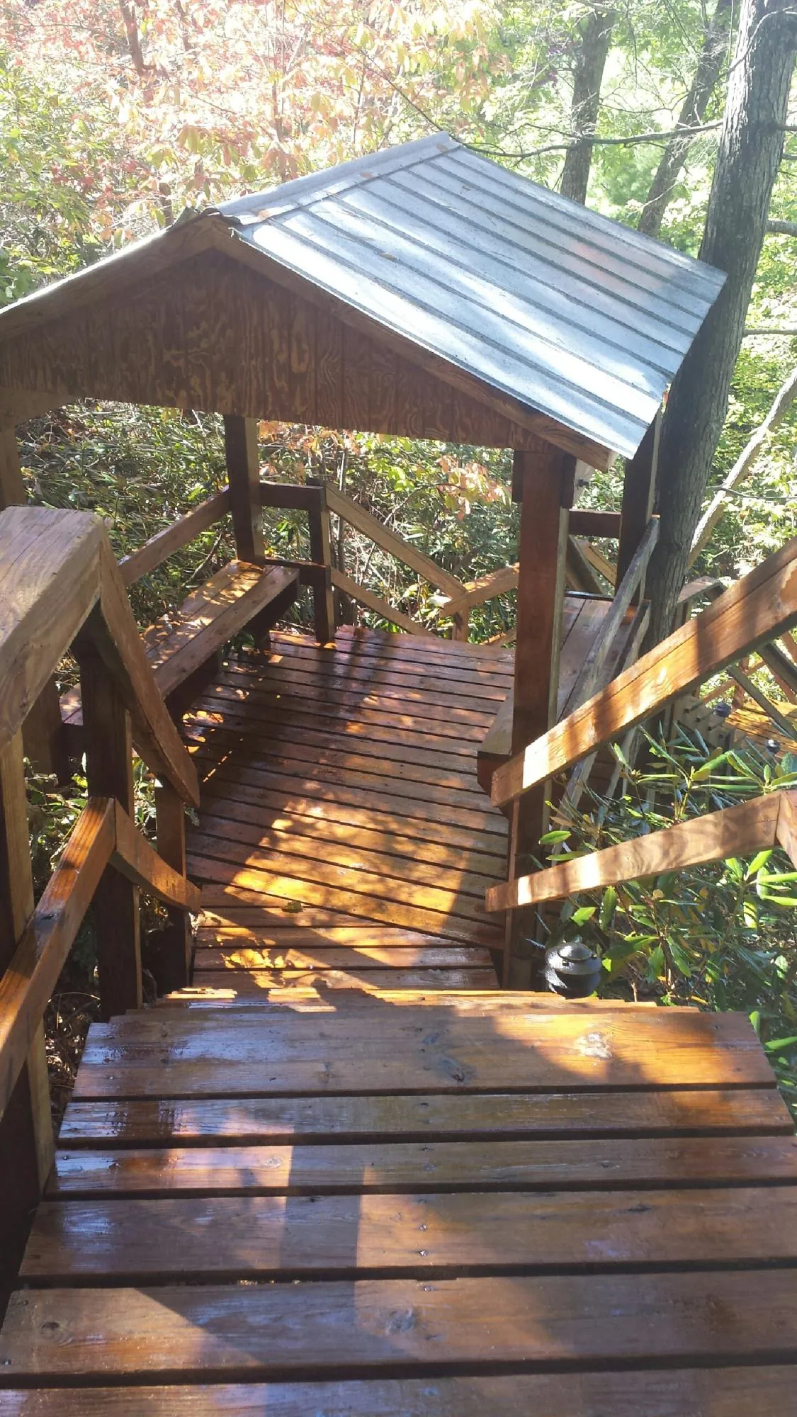 Freshly stained wood walkway and covered shelter with a metal roof in Higganum