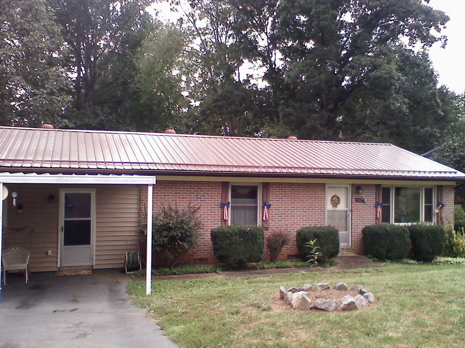 Bronze metal roof and carport on a brick ranch home — Roof Repair work by our crew in Higganum